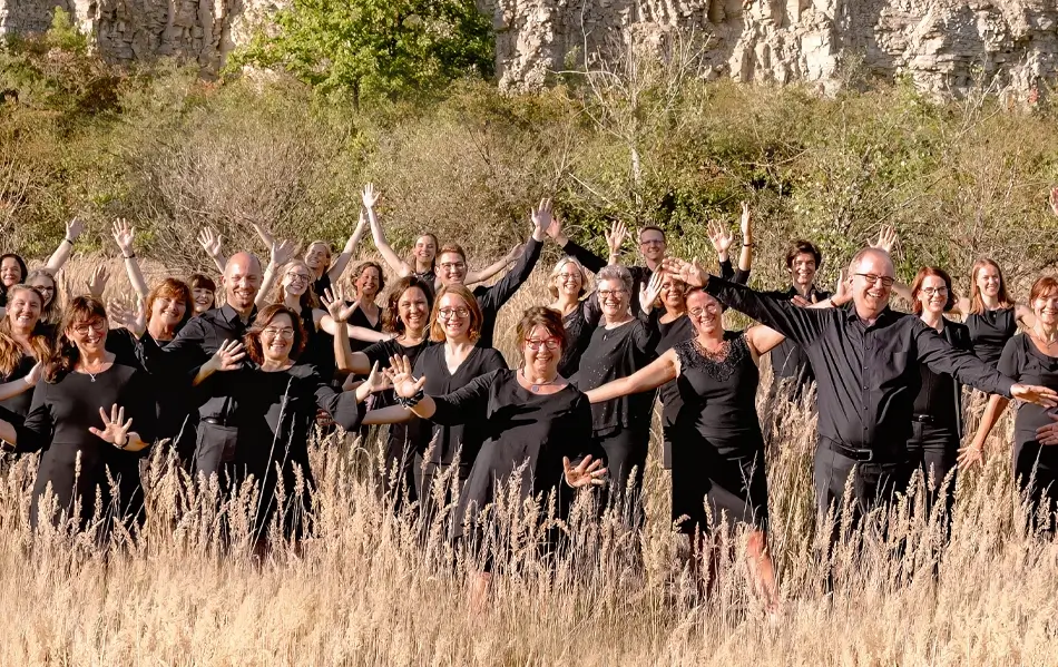 Die Mitglieder des Vocalensembles Erwitte stehen in einer Wiese